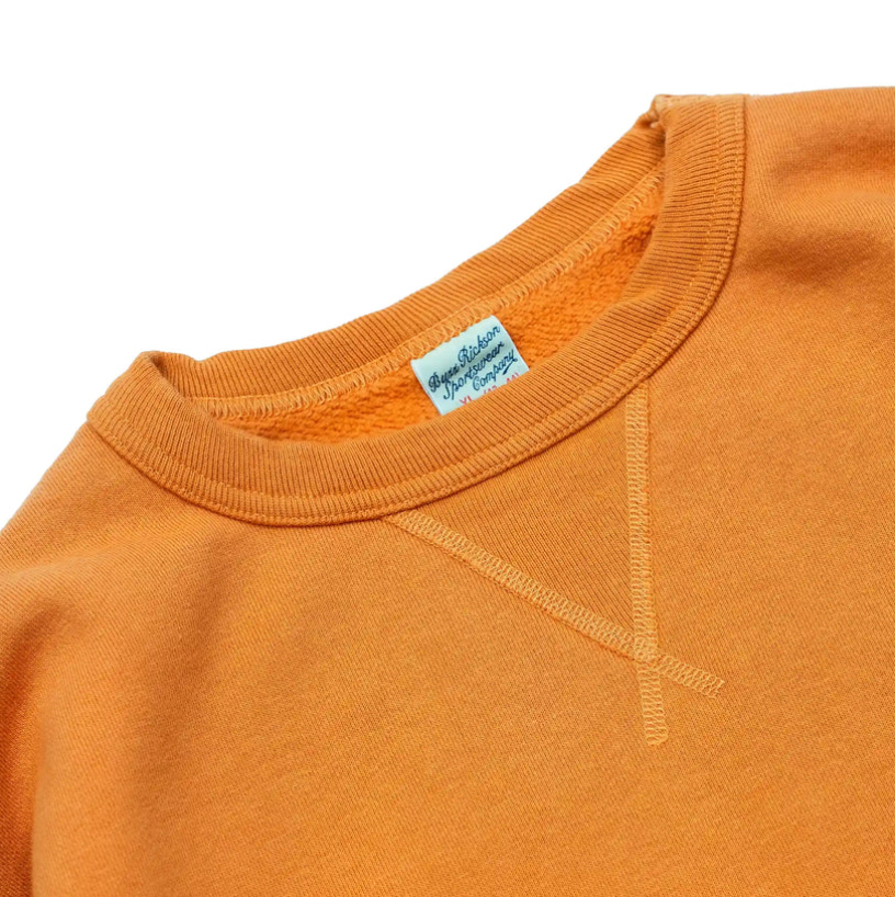 Back view of Buzz Rickson's orange sweatshirt, highlighting the classic fit and structure.